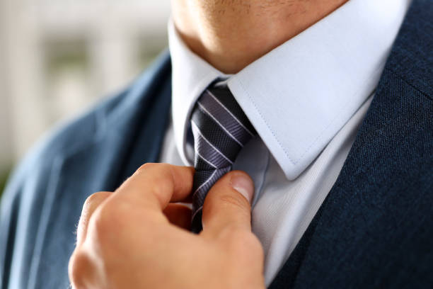 istock Male arm in blue suit set tie closeup 876838116