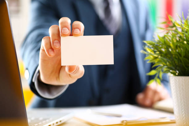 istock Male arm in suit give blank calling card 876838128