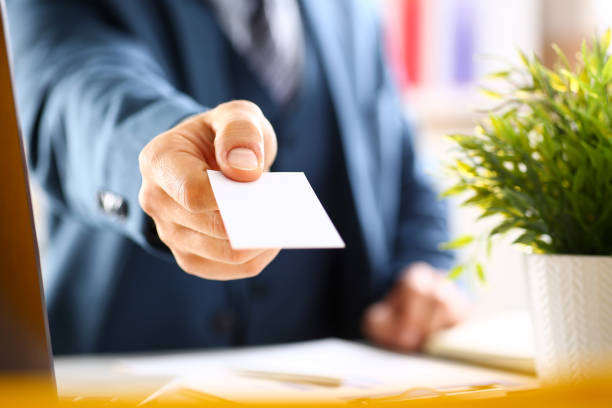 istock Male arm in suit give blank calling card 876838136