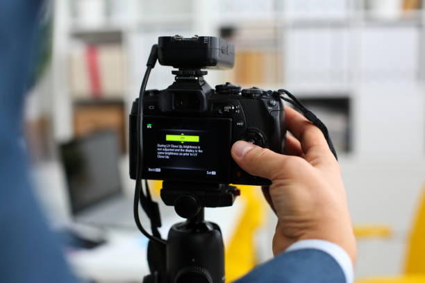 istock Male arms in suit mount camcorder to tripod 876838210
