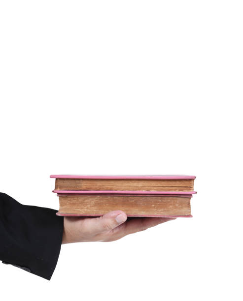 istock Business hand holding old books, isolated on white background. 876851222