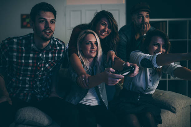 istock Cheerful friends playing video games 876851888