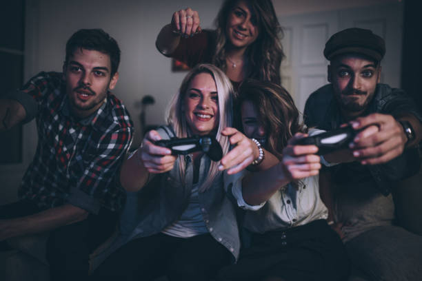 istock Happy friends playing video games 876854446