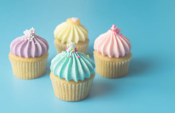 istock Colorful Pastel Cupcake on blue pastel background with blue cupcake on focus 876855446