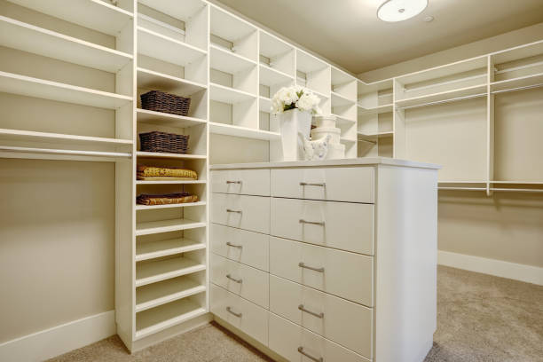 istock Huge walk-in closet with shelves, drawers and shoe racks. 876858250