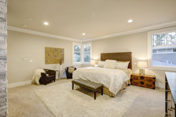 istock Beige and brown master bedroom boasts tufted queen bed 876858334