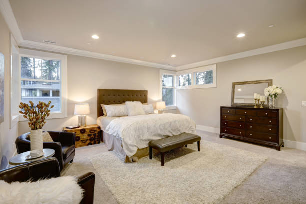 istock Beige and brown master bedroom boasts tufted queen bed 876858614