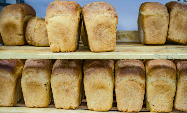 istock Fresh baked white bread on wooden boards 876867886