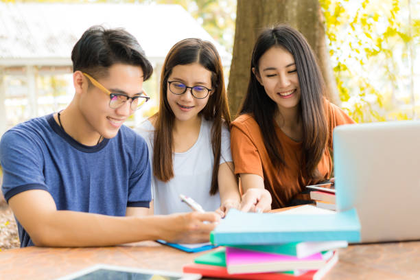 istock Students helping friend consult,totor,teamwork working hard exam study in university campus or high school education with technology knowledge on table meeting together 876868318