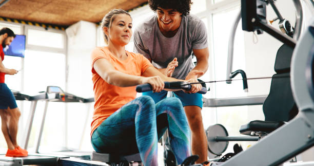 istock Personal trainer helping woman reach goals 876868840