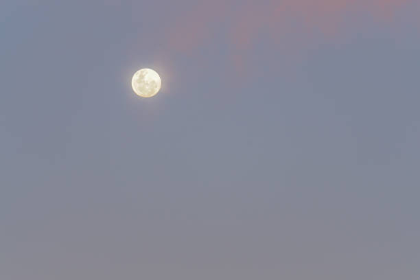 istock bright full moon in clear sky after sunset 876873412