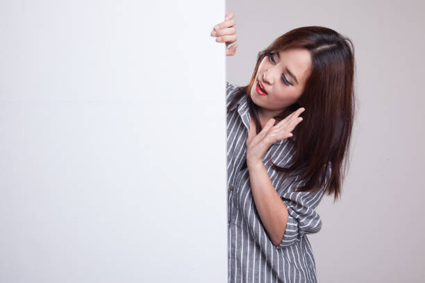 istock Excited young Asian woman with blank sign. 876873570