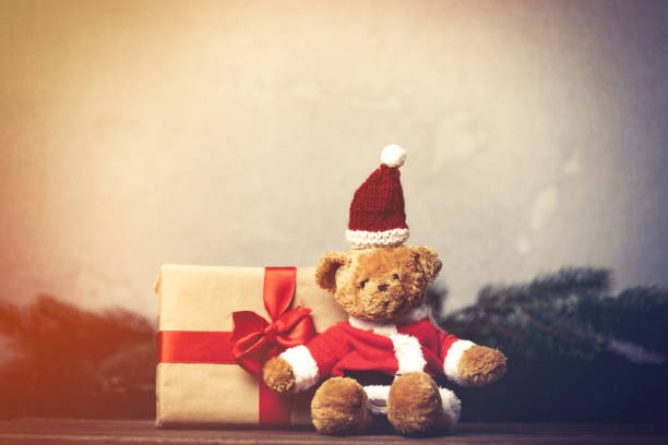 istock Christmas gift with bowknot and teddy bear toy 876873650