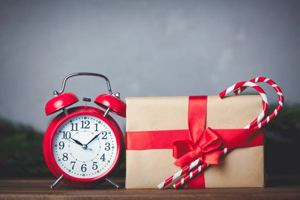 istock Christmas gift with bowknot and retro alarm clock 876873686