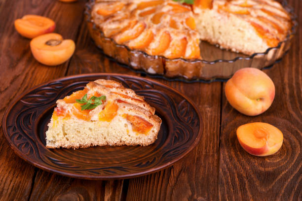 istock Piece of apricot cake on wooden table. 876876630