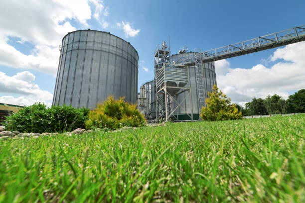 istock Large modern granary. In the foreground there is a luscious green lawn grass 876877174