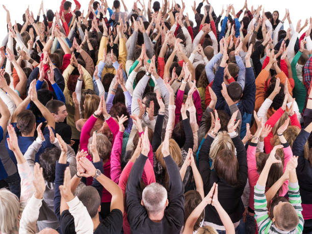 istock Rear view of large group of people applauding. 876877662