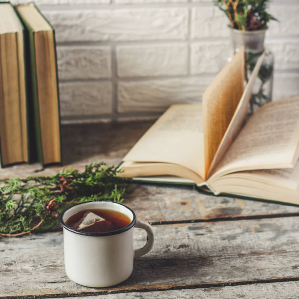 istock a cup of fresh and hot tea, and reading books 876880498