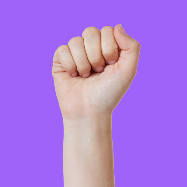 istock Hand making a fist counts '5' against purple background. 876886944