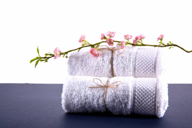 istock White towel rolled up on a blue background 876886988