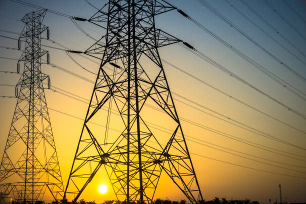 istock Electricity station. Close up high voltage power lines at sunset. 876887786