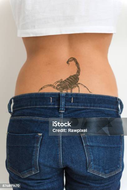 A Woman Is Showing Her Tattoo On Her Hips Stock Photo - Download Image Now - Tattoo, Scorpion, Back - iStock A Woman Is Showing Her Tattoo On Her Hips Stock Photo - Download Image Now - Tattoo, Scorpion, Back - iStock