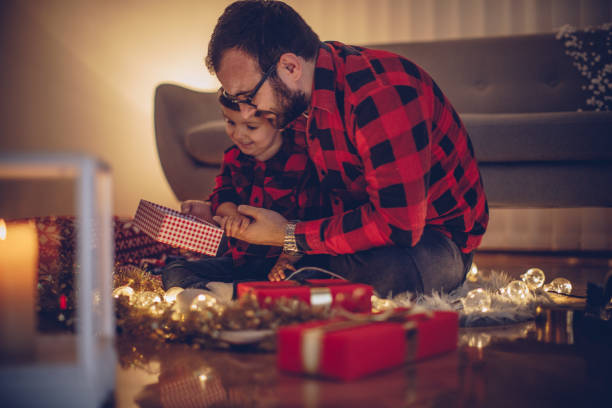 istock Father and daughter opening a Christmas gift 876892290