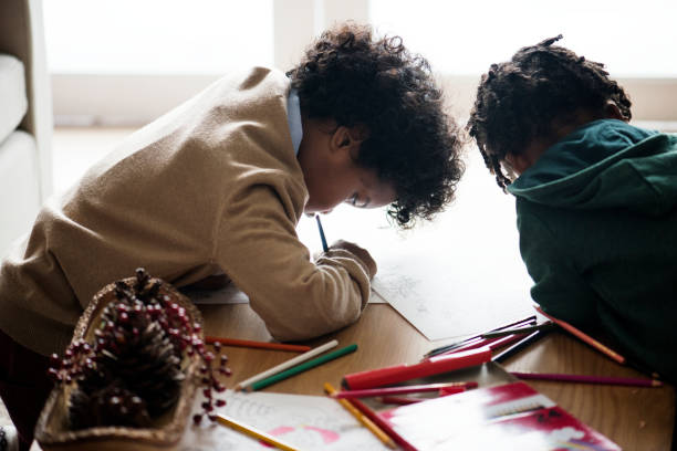 istock Kids enjoying the coloring book 876893934