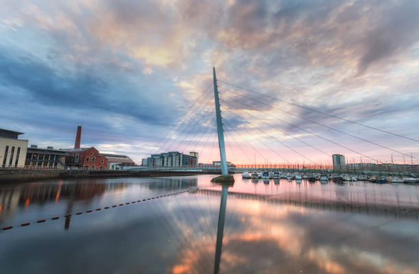 Swansea marina and Millennium bridge Sunrise at the Millennium bridge, also known as the Sail bridge, spanning the river Tawe in Swansea, South Wales, UK swansea stock pictures, royalty-free photos & images
