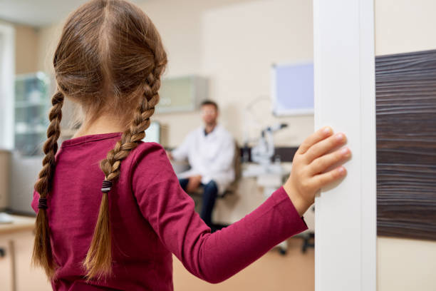 istock Scared Little Girl Entering Doctors Office 876900028