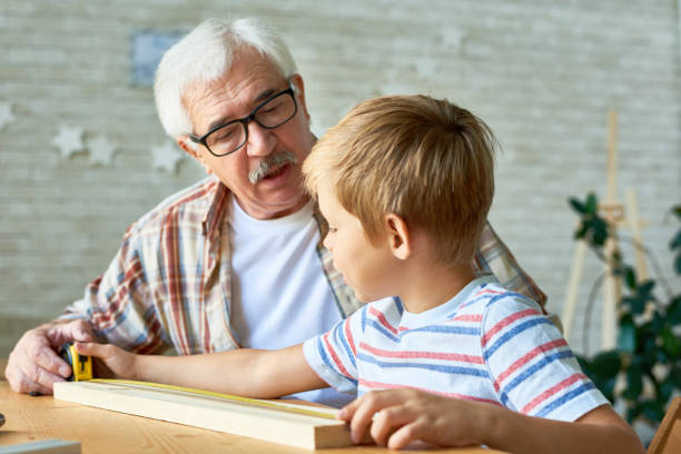 istock Loving Grandfather Spending Teaching Grandson Craft 876900294