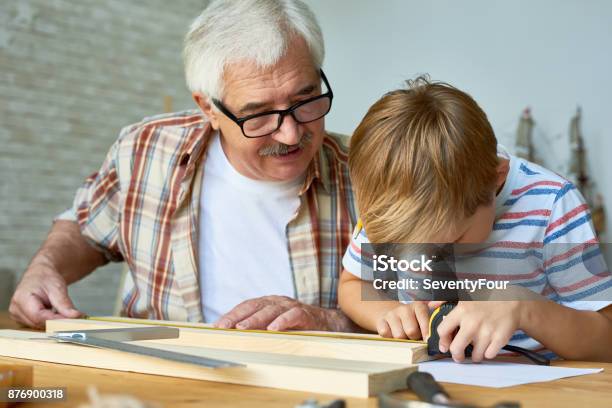 Grandfather Teaching Boy Carpentry Stock Photo - Download Image Now - Grandfather, Craft, Grandson