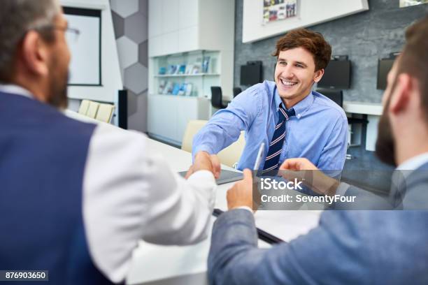 Young Businessman In Greeting Partners In Meeting Stock Photo - Download Image Now - Job Interview, Young Men, Young Adult