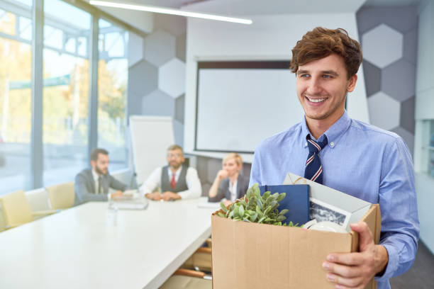 Happy Young Man Starting Career in Business Portrait of smiling young man holding box of personal belongings being hired to work in business company, copy space quitting a job stock pictures, royalty-free photos & images