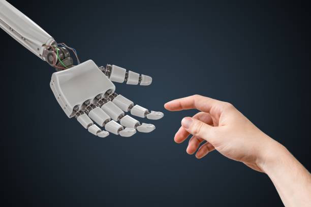 istock Robot hand and human hand are touching. Artificial intelligence and cooperation concept. 876904126