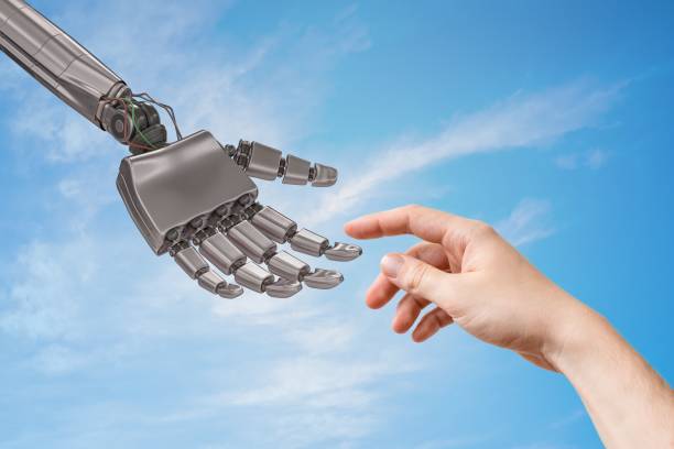 istock Robot hand and human hand are touching. Artificial intelligence and cooperation concept. 876904128