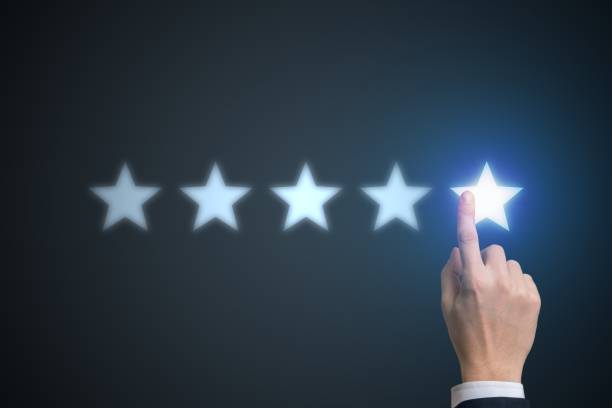 istock Ranking concept. Human hand is rating with 5 stars. 876904132