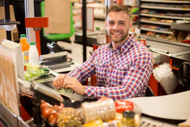 istock Handsome Young Cashier Working in Supermarket 876907470