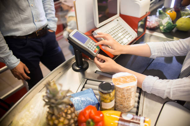 istock Cashier Using Payment Terminal in Supermarket 876907512