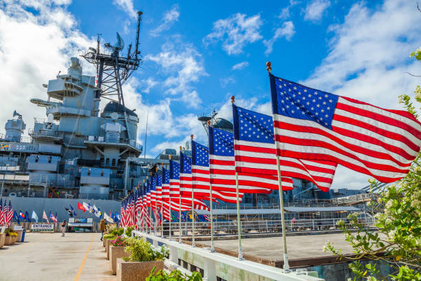 HONOLULU, OAHU, HAWAII, USA - AUGUST 21, 2016:American flags in line at Missouri Warship Memorial in Pearl Harbor Honolulu Hawaii, Oahu island of United States. National historic patriotic landmark.
