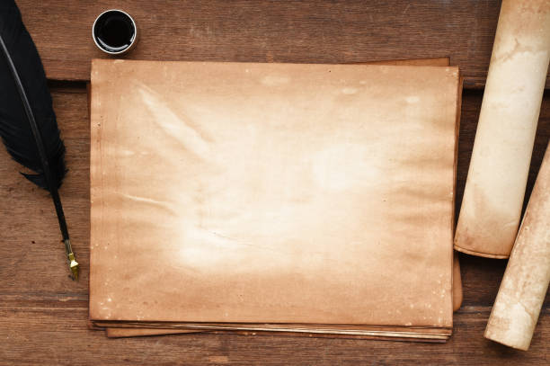 istock old paper on brown wood texture with feather and ink 876909180