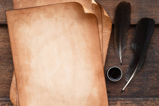 istock old paper on brown wood texture with feather and ink 876909184