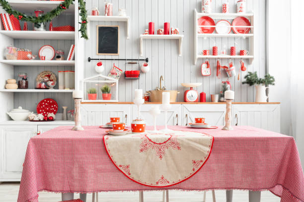istock Interior light grey kitchen and red christmas decor. Preparing lunch at home on the kitchen concept. Focus on table and wall 876914248