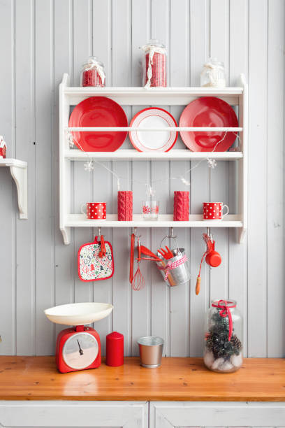 istock shelves with dishes. Interior light grey kitchen and red christmas decor. Preparing lunch at home on the kitchen concept. 876914306