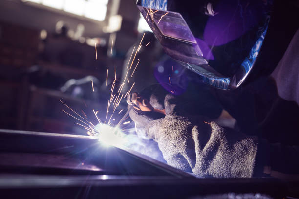 istock Manual worker welding metal in a factory. 876919262