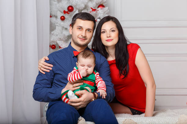 istock Parents with daughter in a Christmas photo session 876920164
