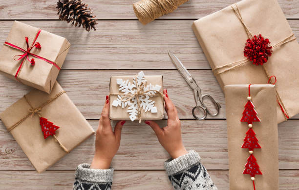 istock Woman's hands holding christmas holiday present decorated with snowflake 876923108