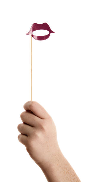 istock Hand holds up photo booth prop shaped like pouting lips 876926958