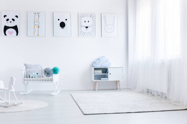 istock Baby's bedroom with white furniture 876927096
