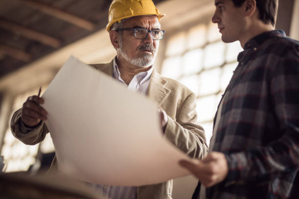 istock Mature manager explaining his worker the new business plan in a workshop. 876930572